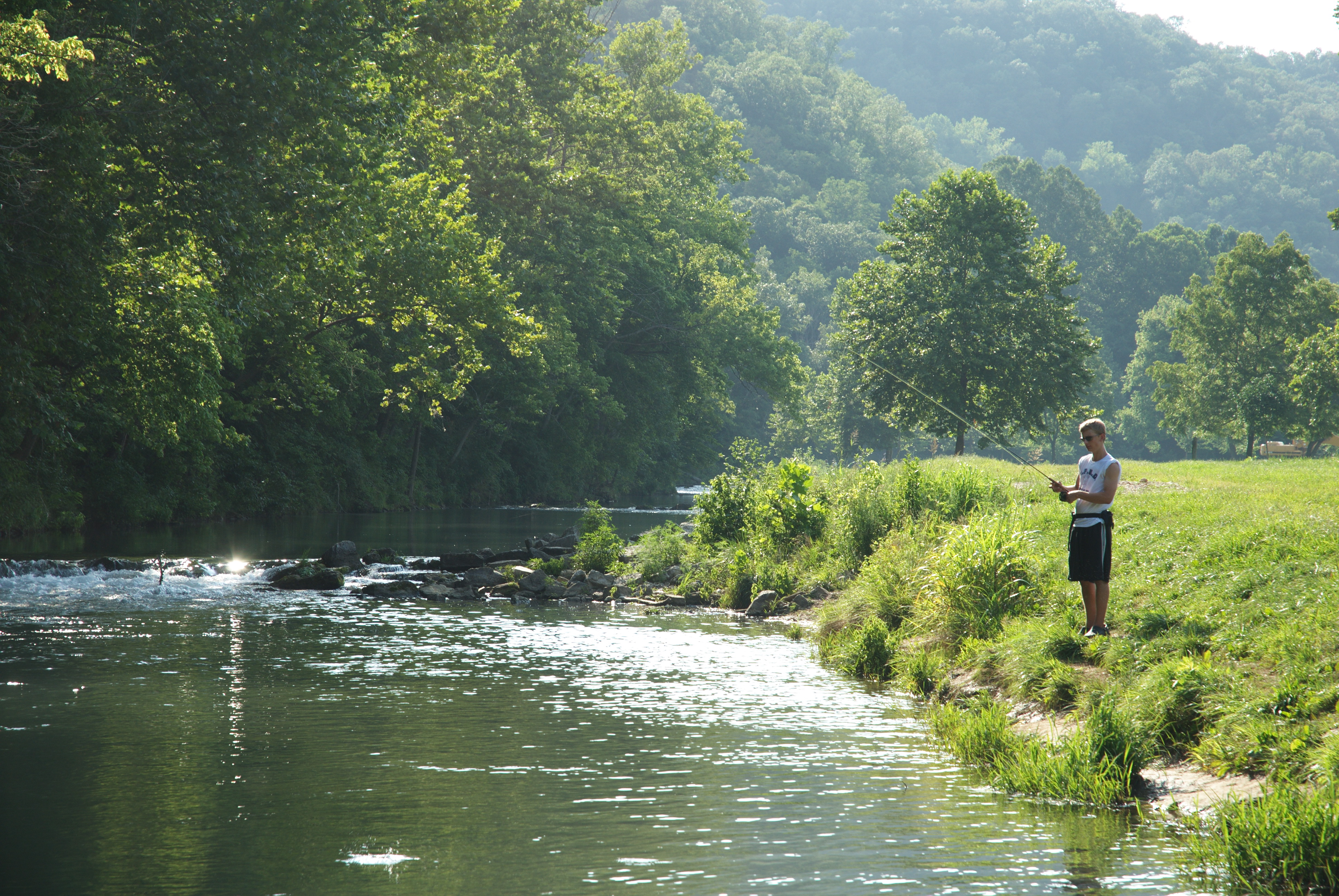 Image of man fishing at a river