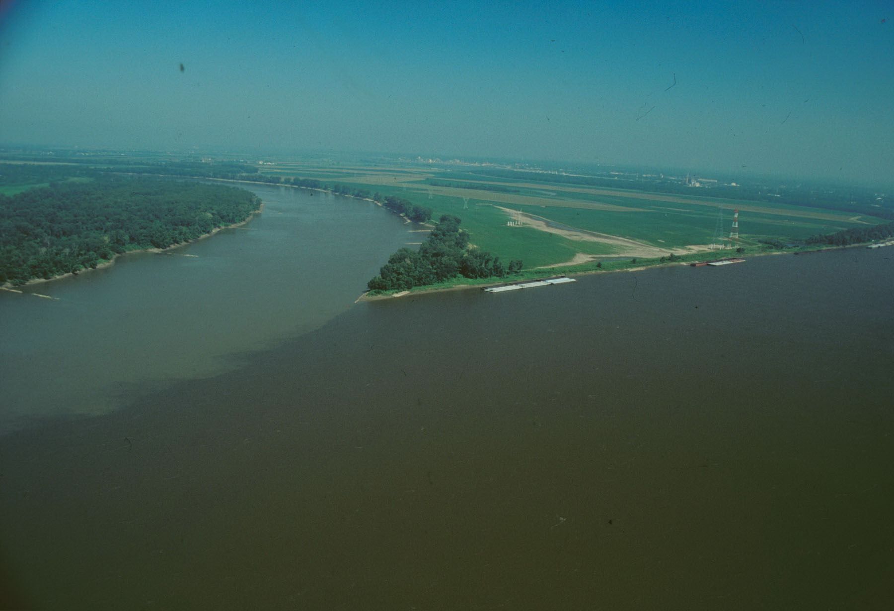 A drone view of a piece of land between a split river