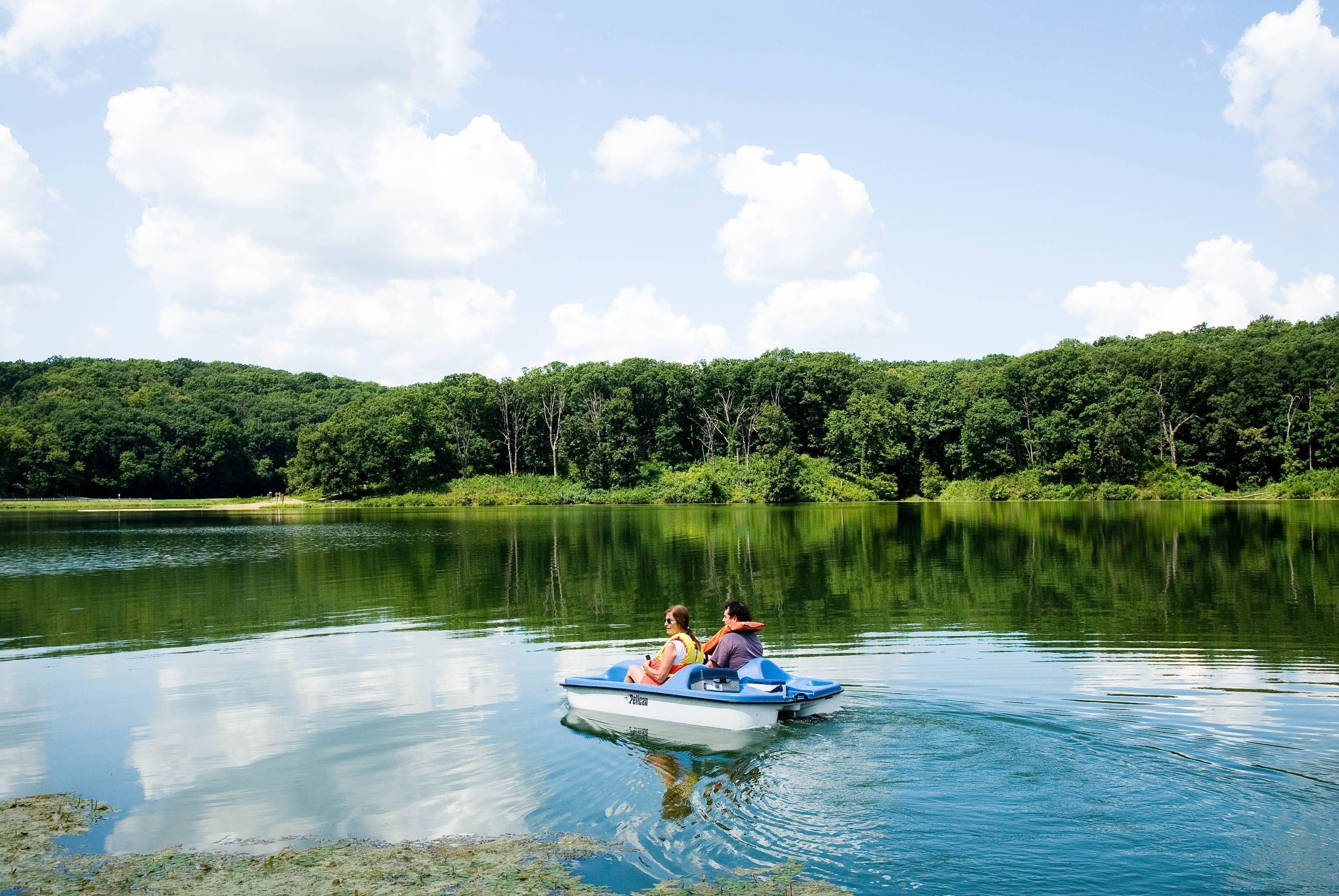 two people in a paddle boat on a body of water