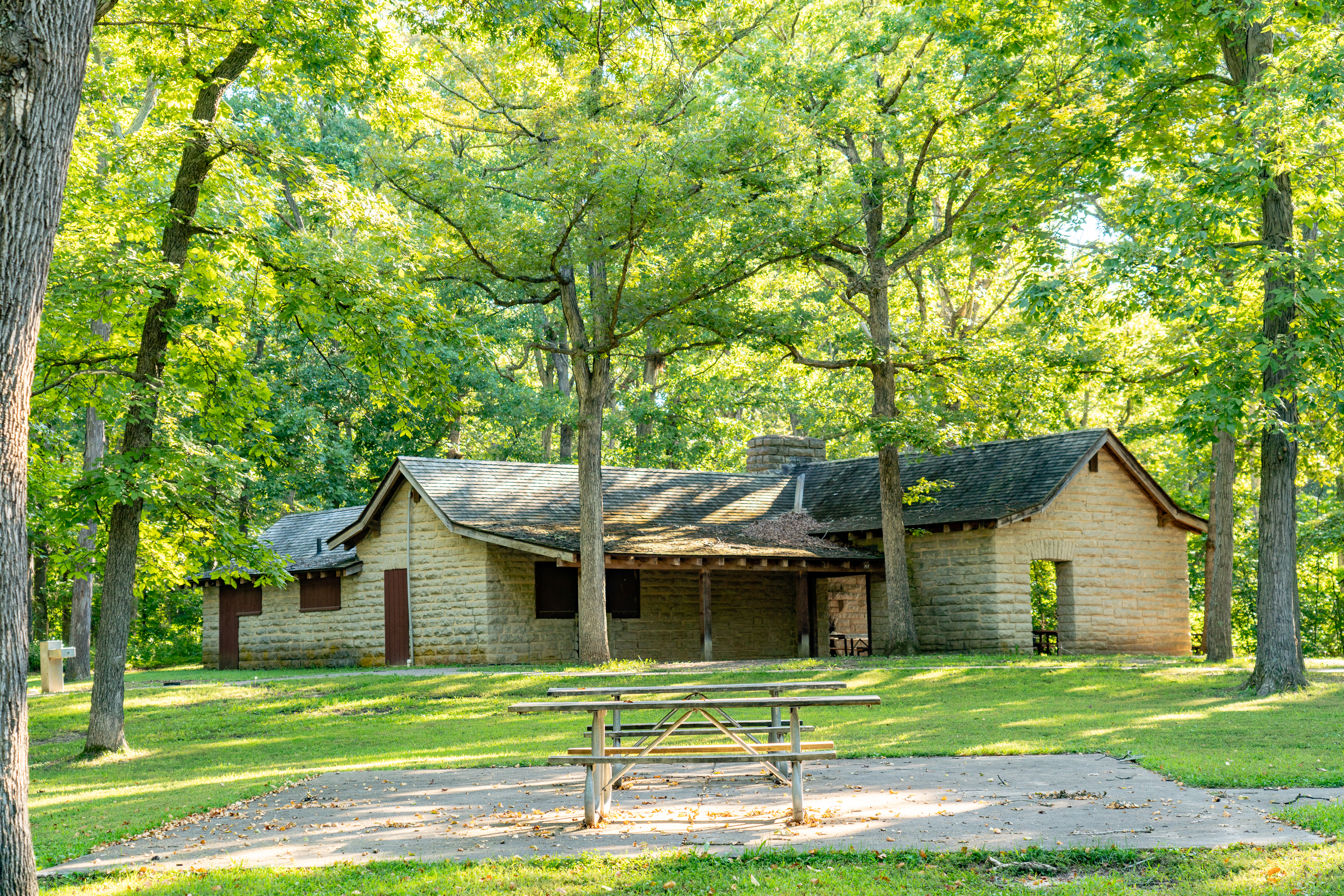 a stone park shelter with picnic tables at Cuivre River State Park