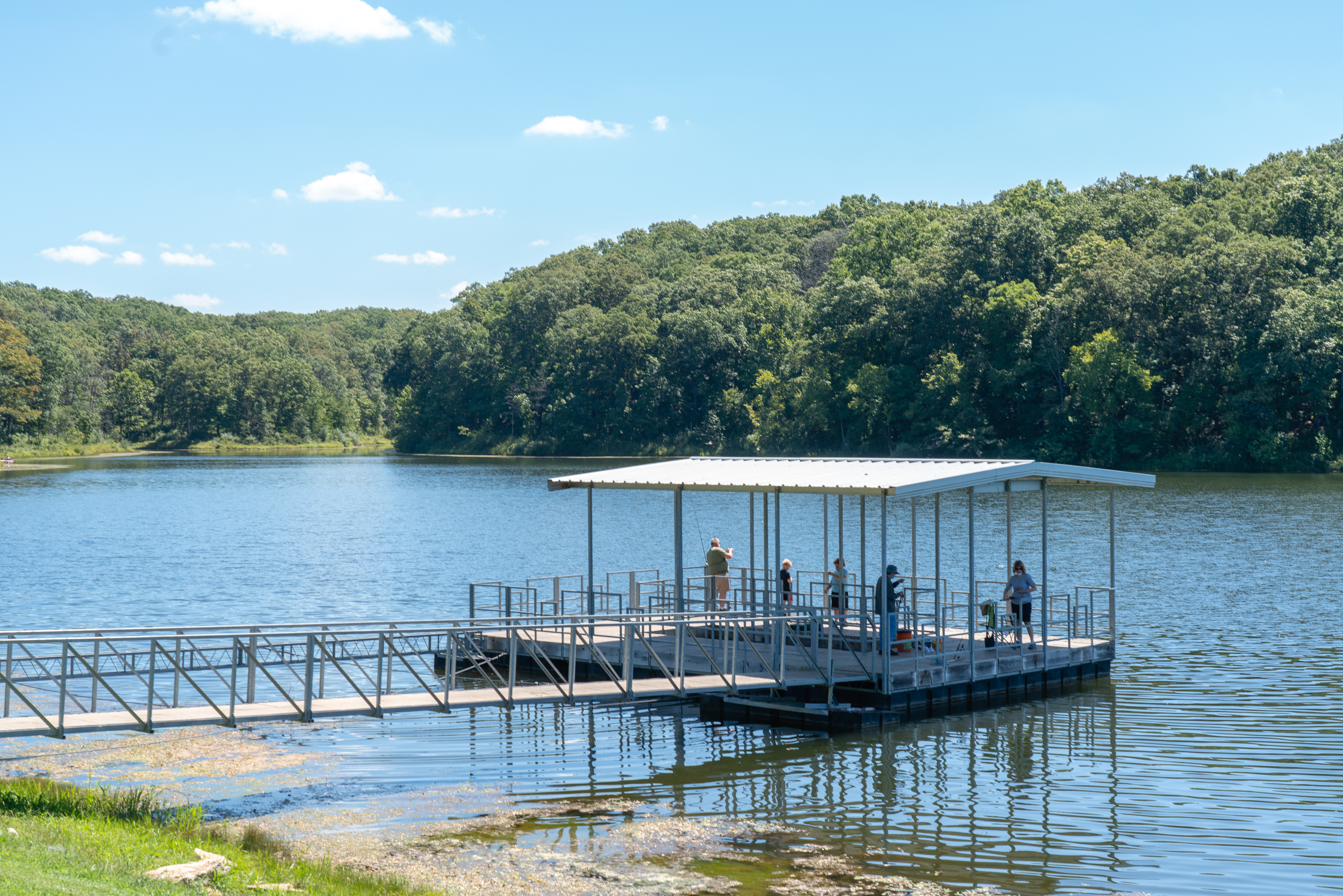 five people fishing off a floating dock in the Cuivre River