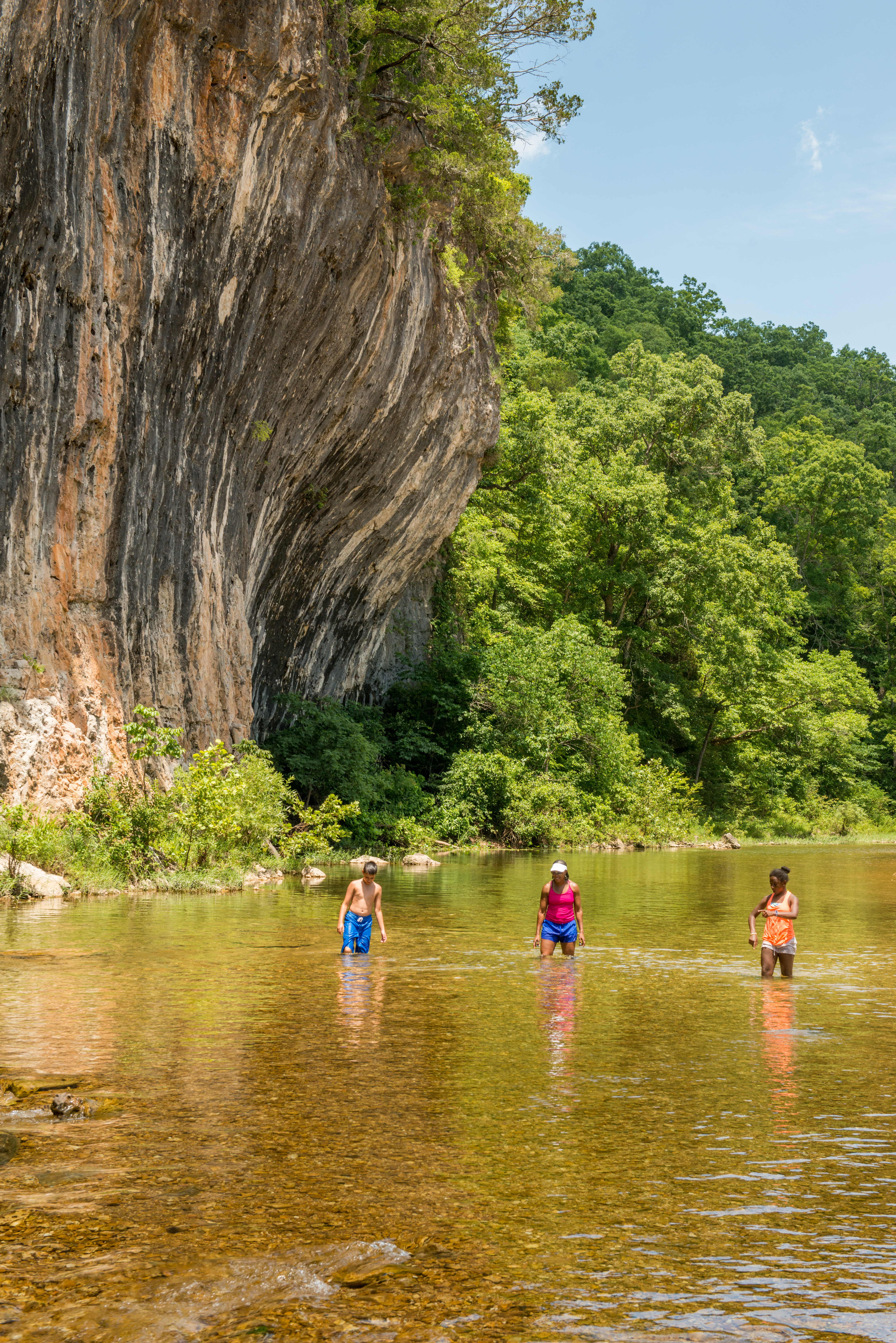 People playing in a shallow river