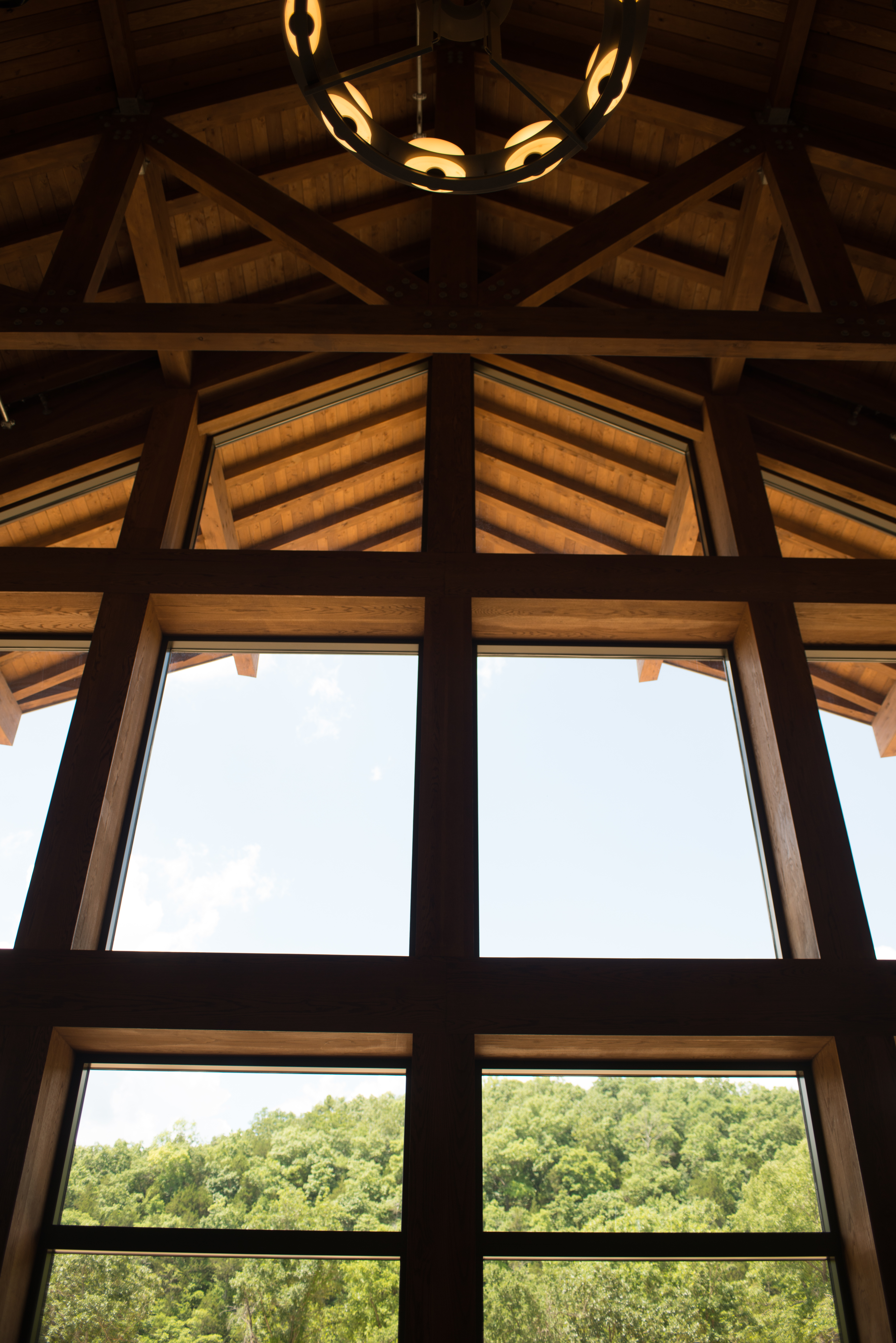 Wooden ceiling with a rustic, round chandelier