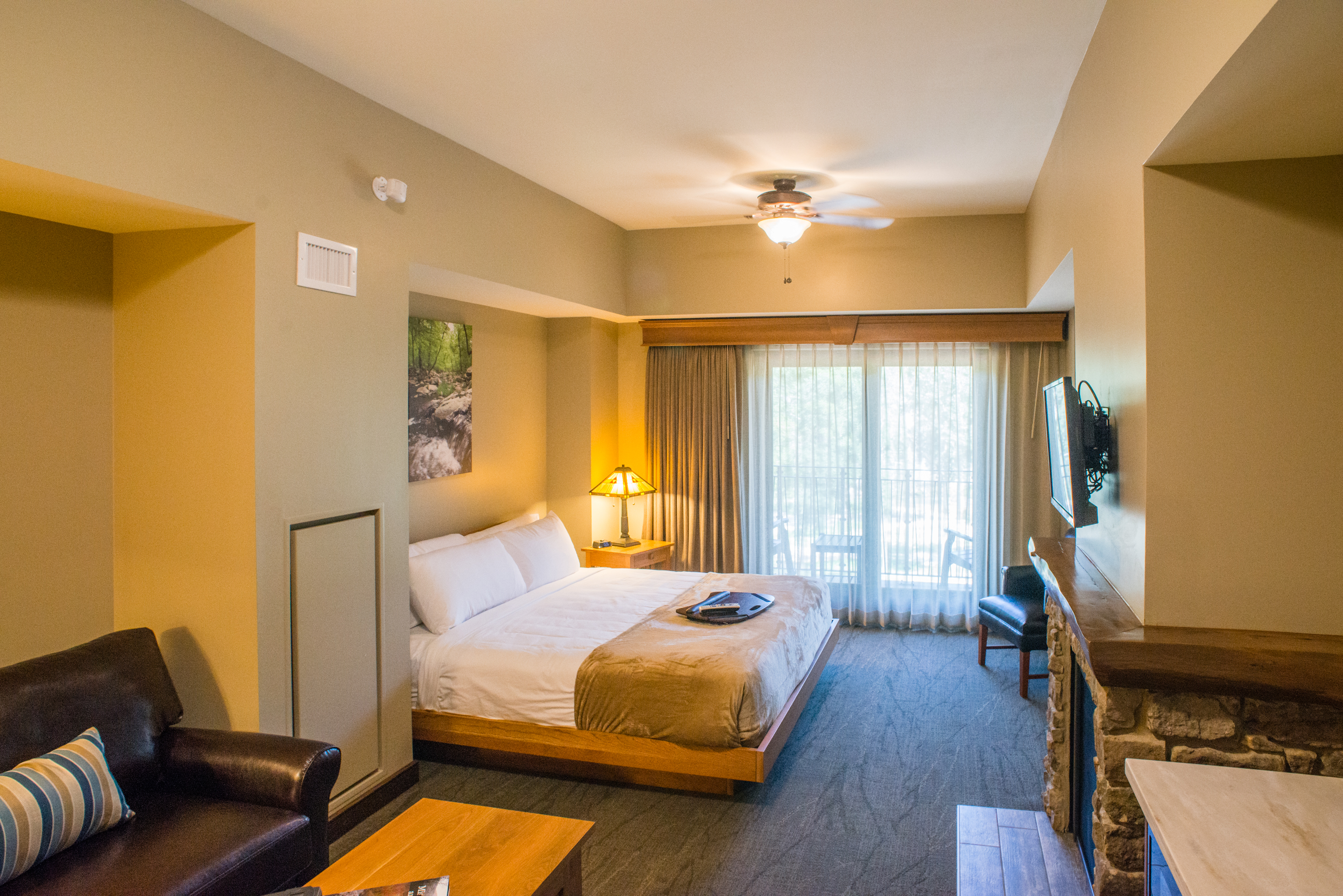 a bedroom with a sitting area and a tv