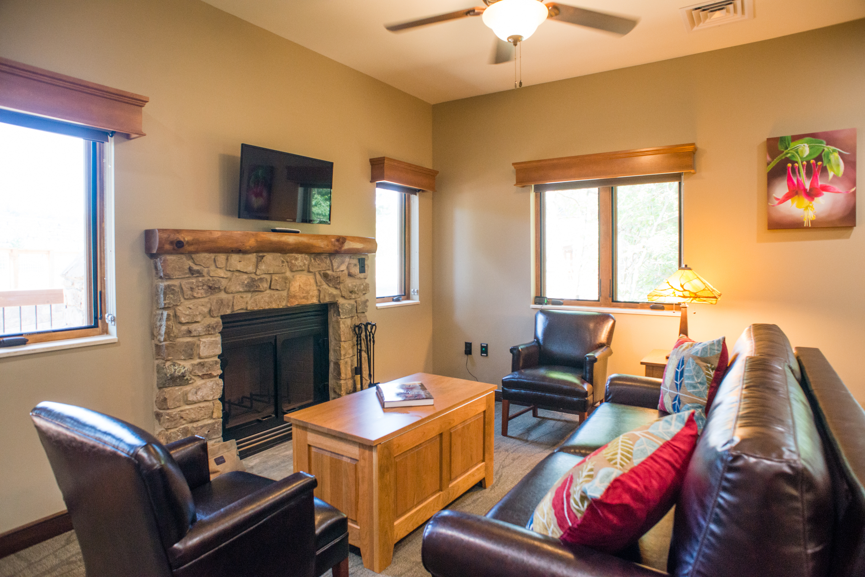 a lounge area with 2 chairs and a couch