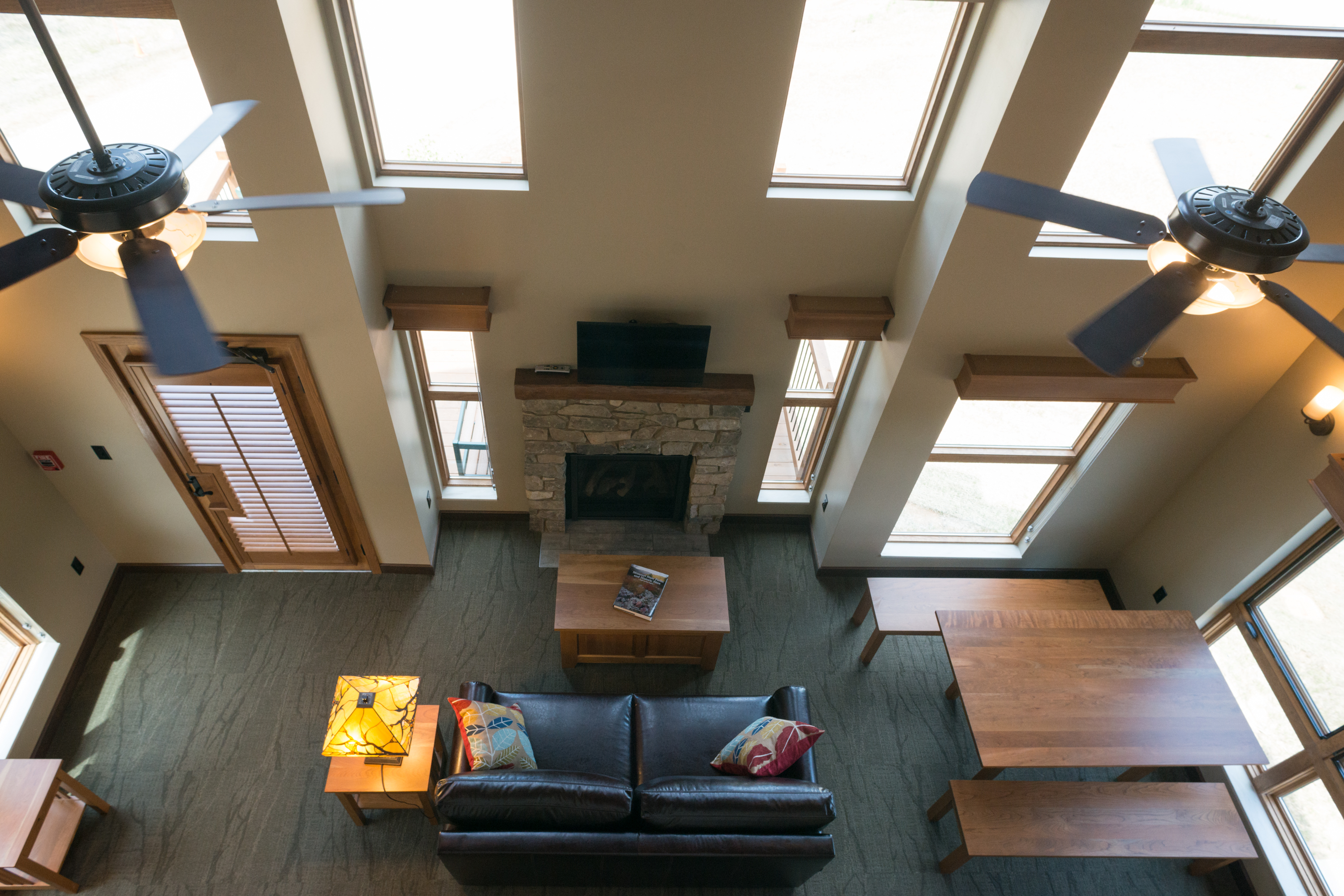 a small lounge area with a couch, TV, and fireplace