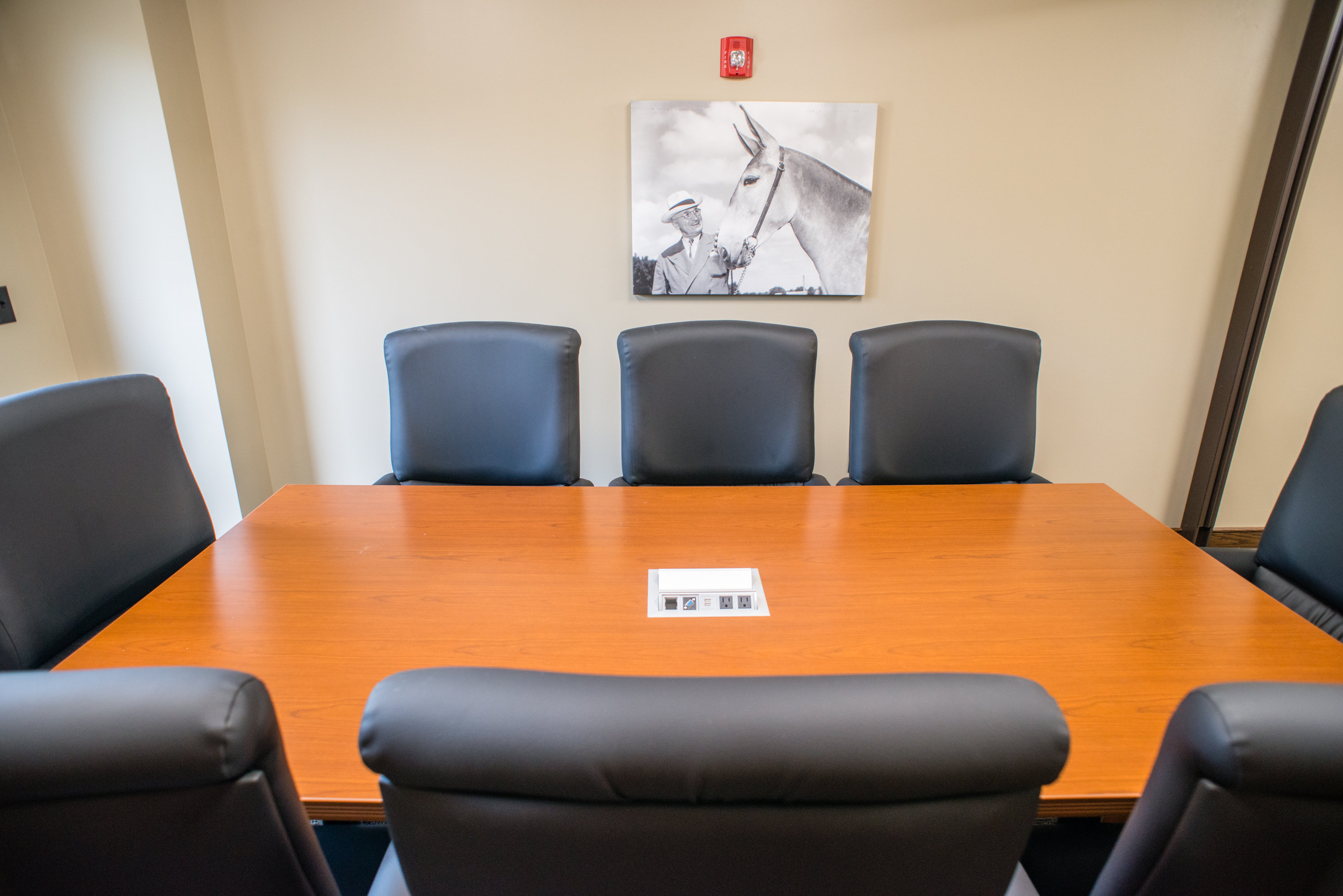 a conference room with a table and eight chairs