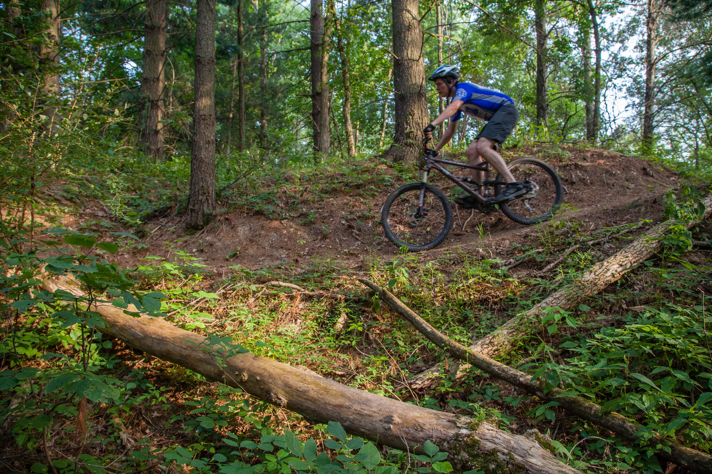 A person riding a bike on a dirk hiking trail