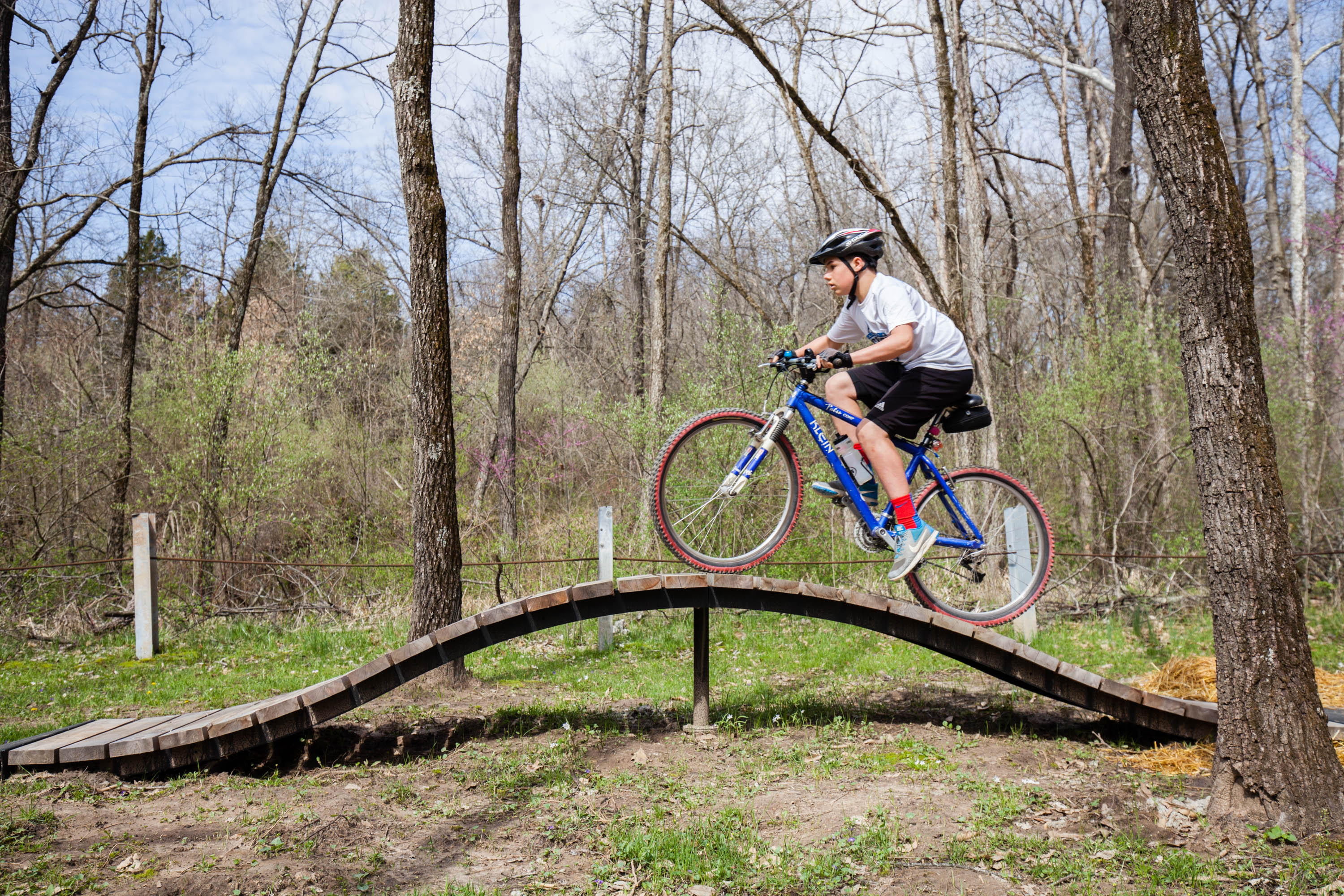 A child riding a bike on a wooden ramp