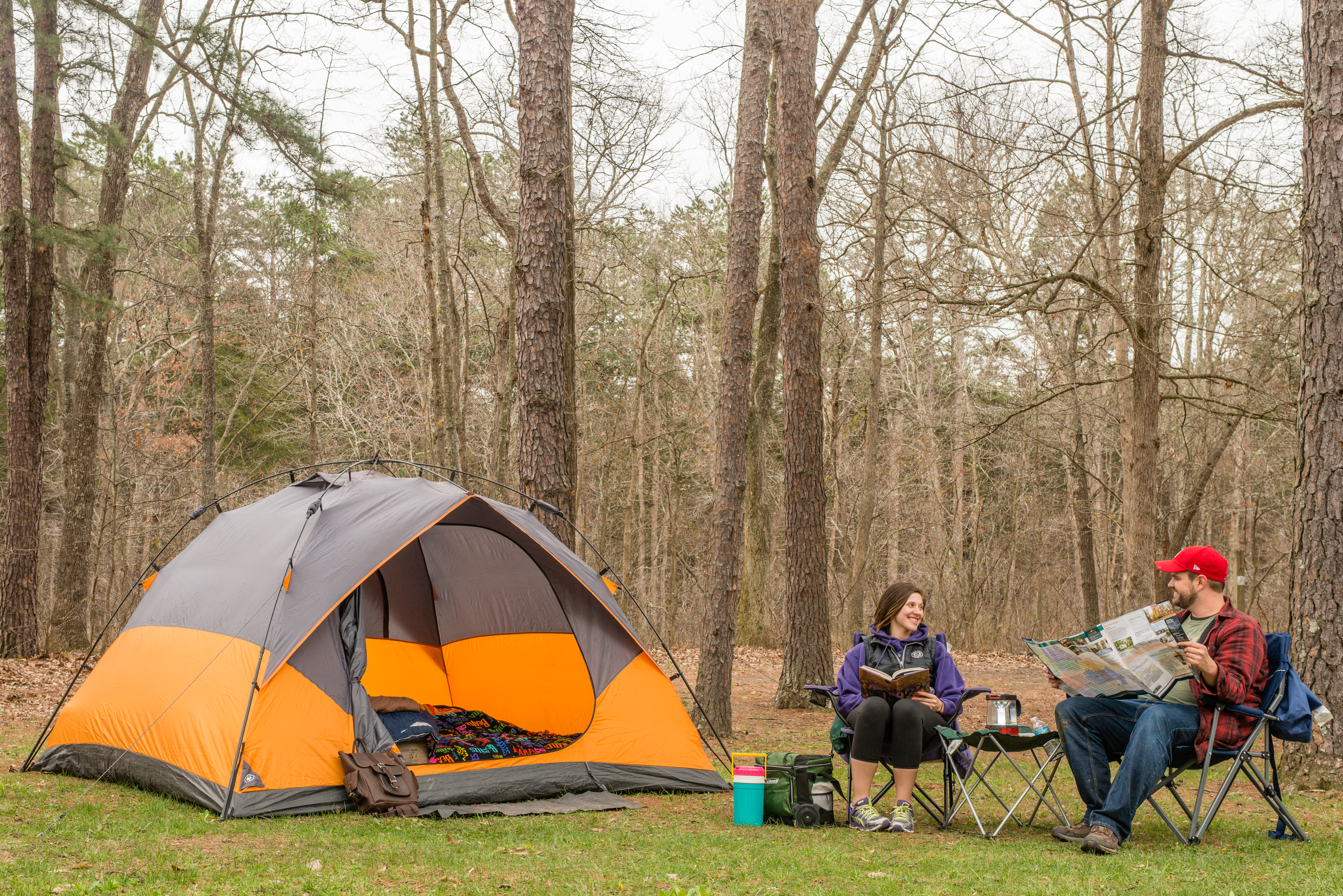Two people sitting outside a tent