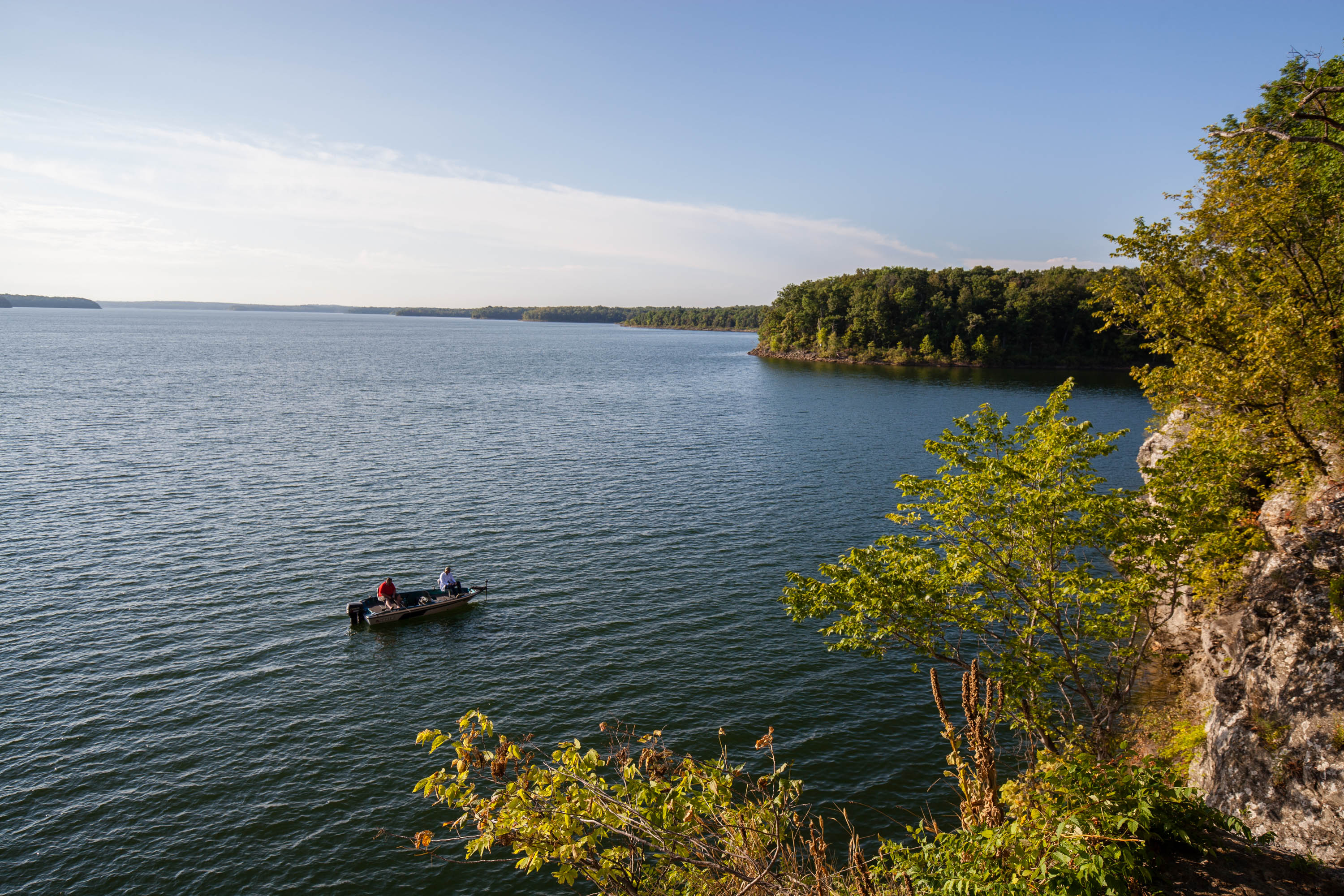 Two people in a boat on a wide river
