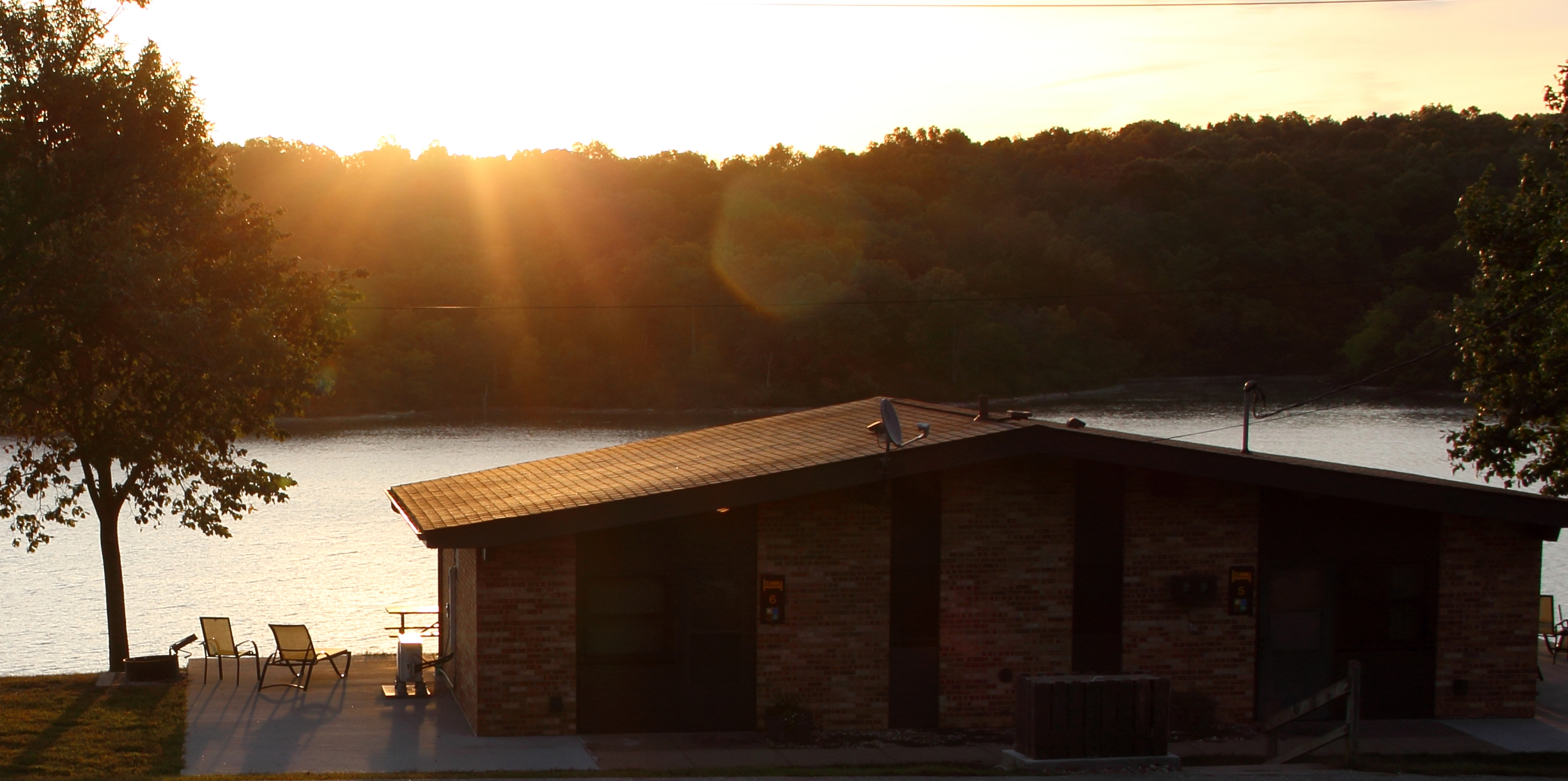 A cabin over looking the water at sunset