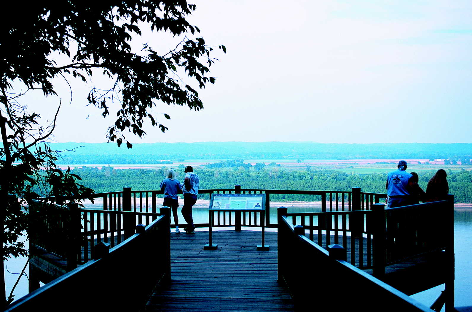 People on a balcony over looking the water
