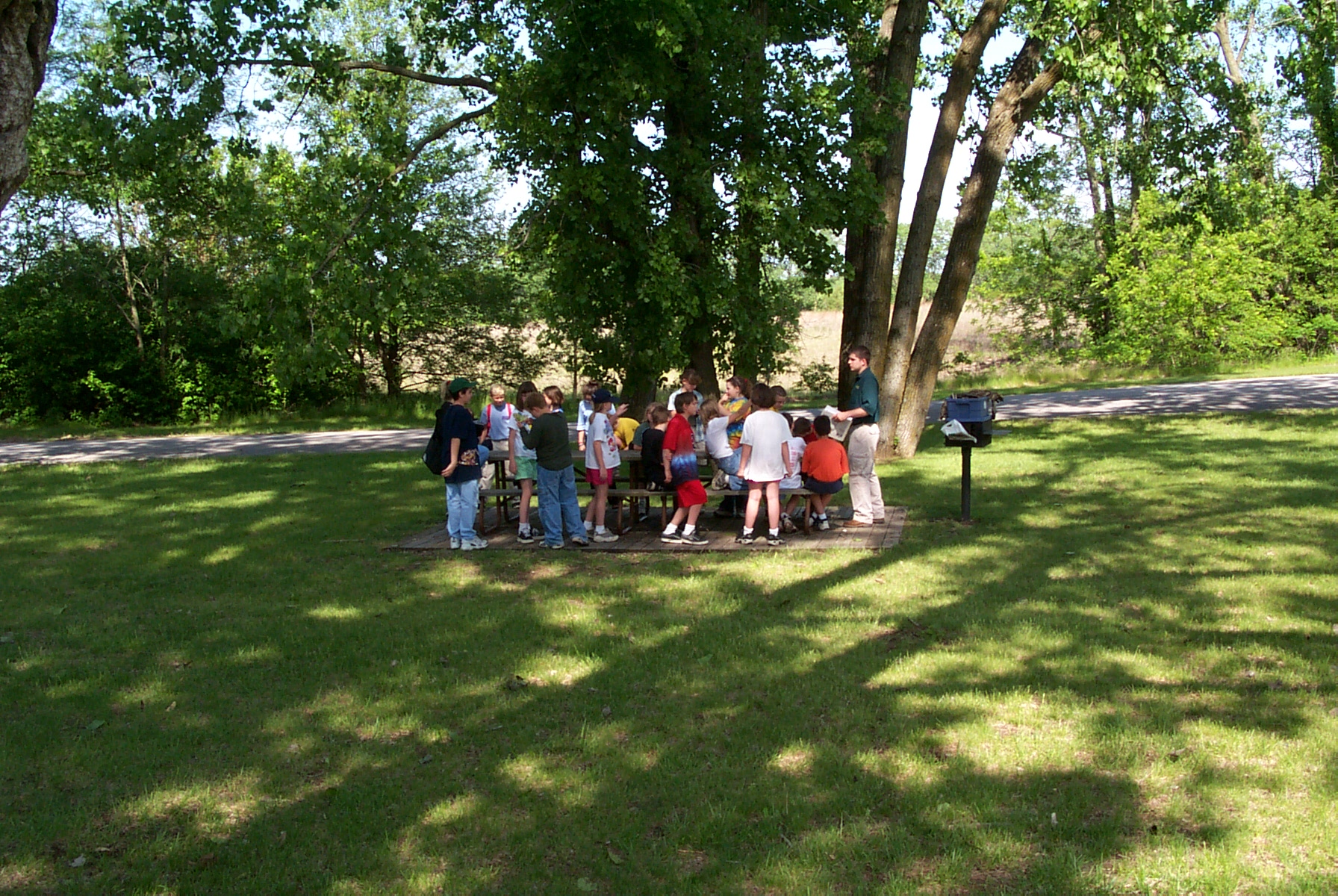 A group gathered around a picnic table