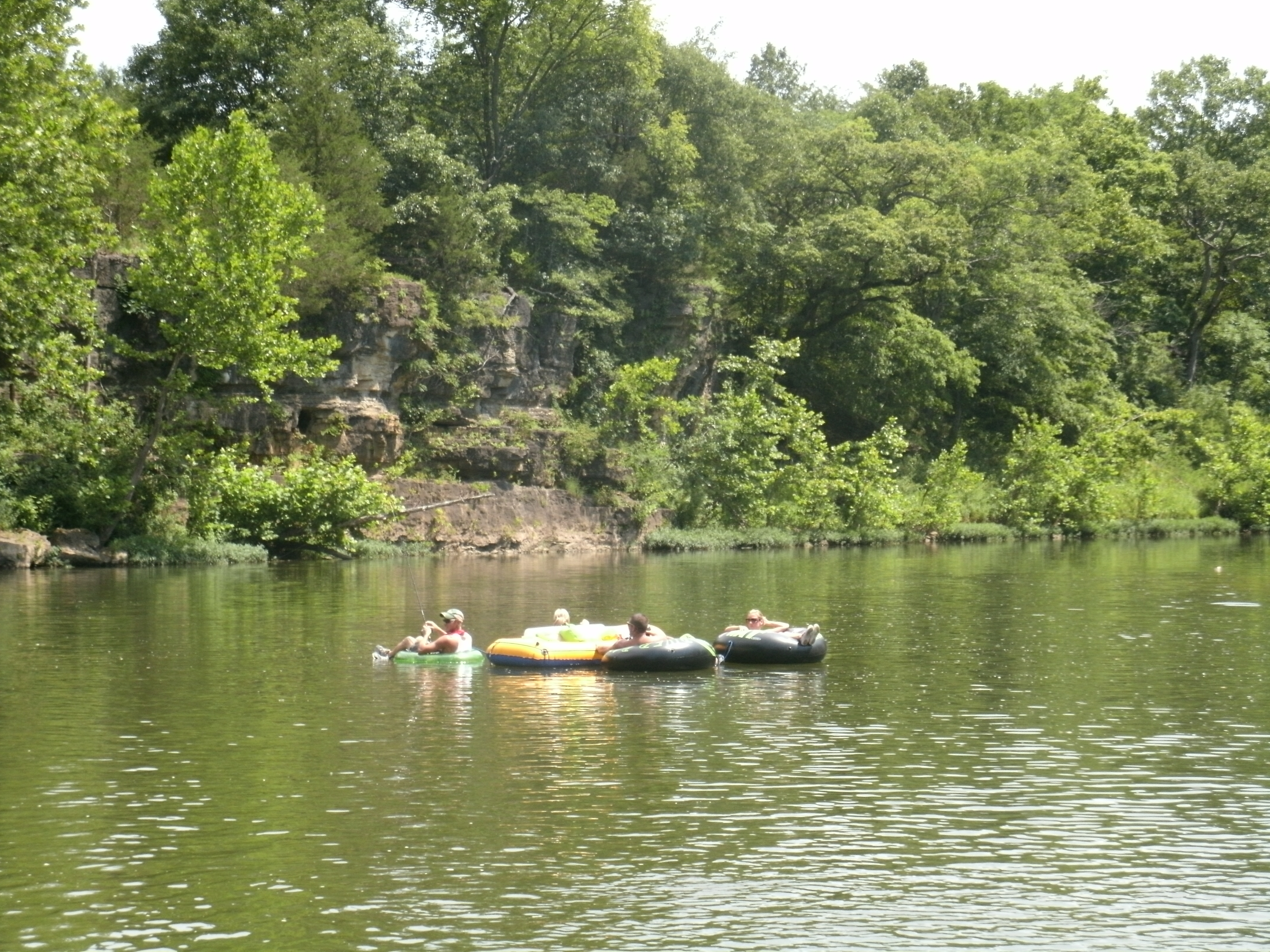 People relaxing in inflatable boats on the water