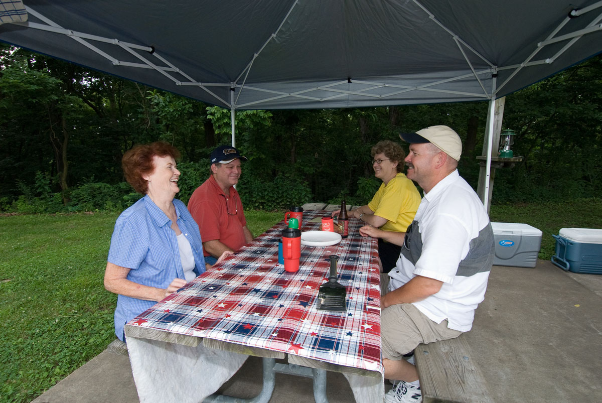 Four people sitting at a picnic table