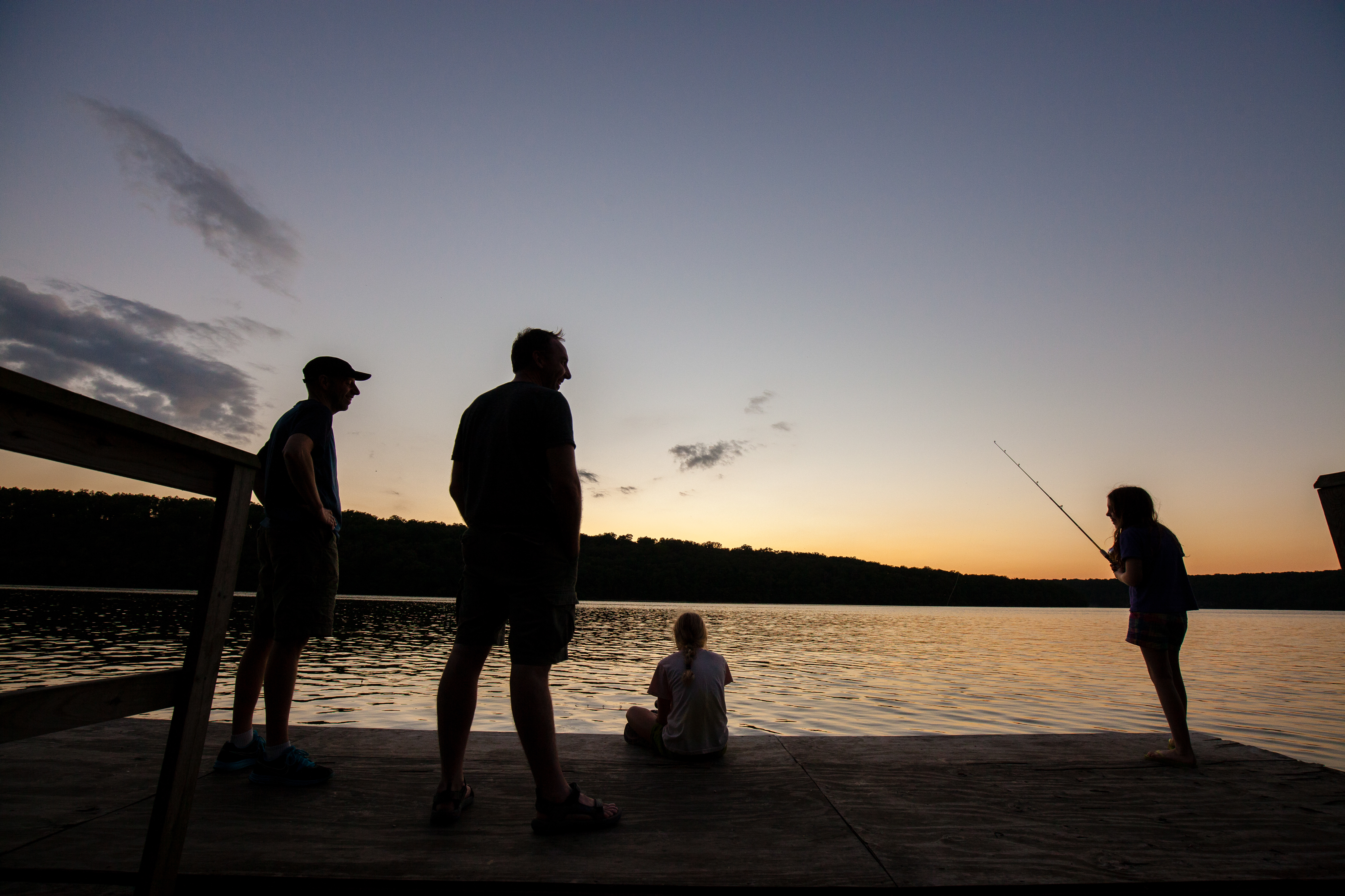 People sitting on the edge of the lake