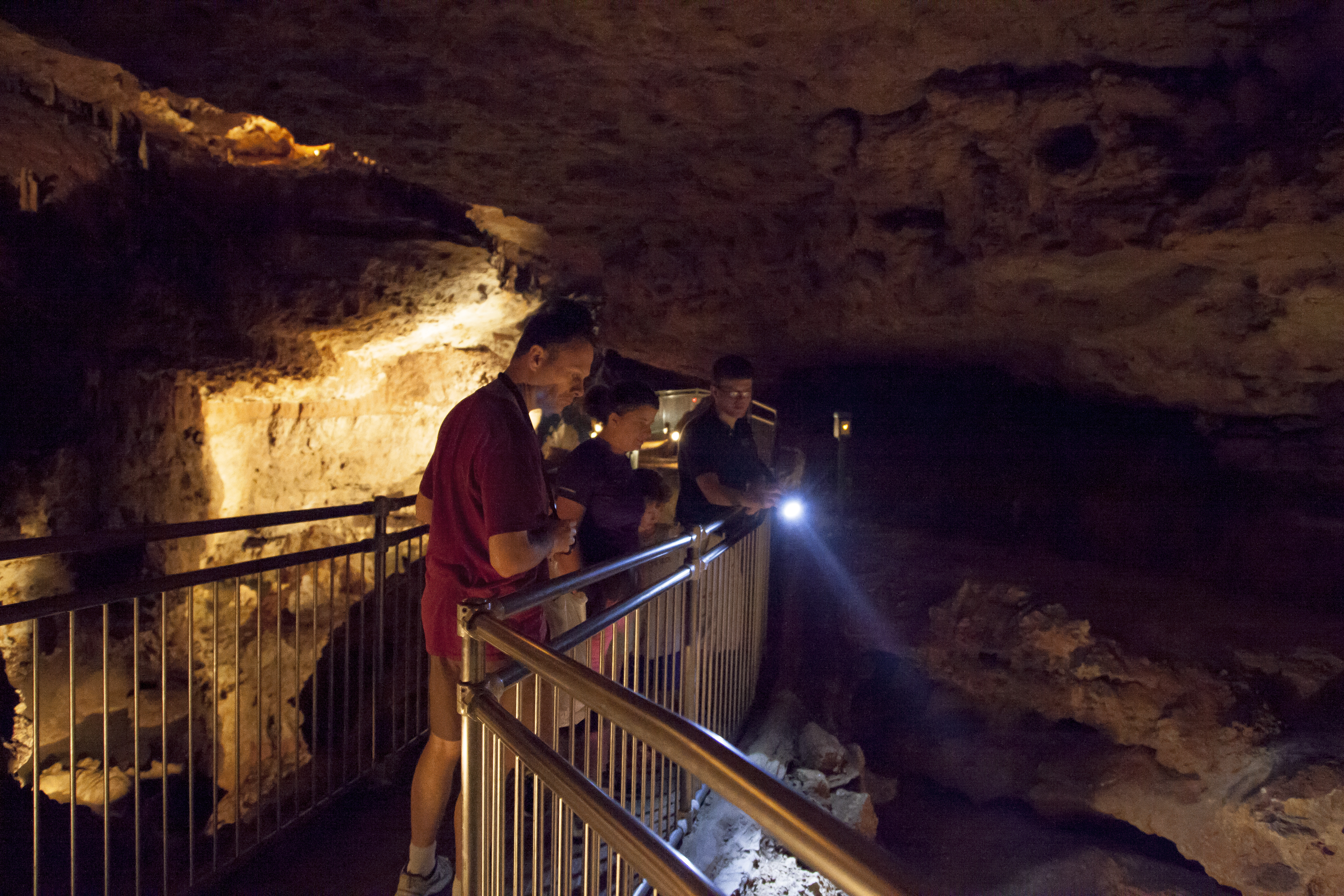 People on a bridge in a cave