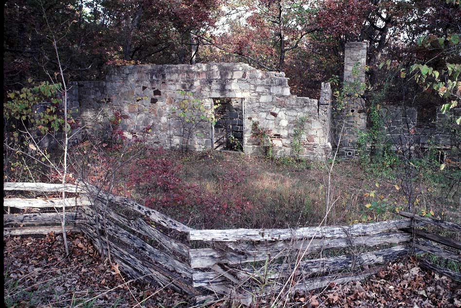 Stone ruins behind a fence