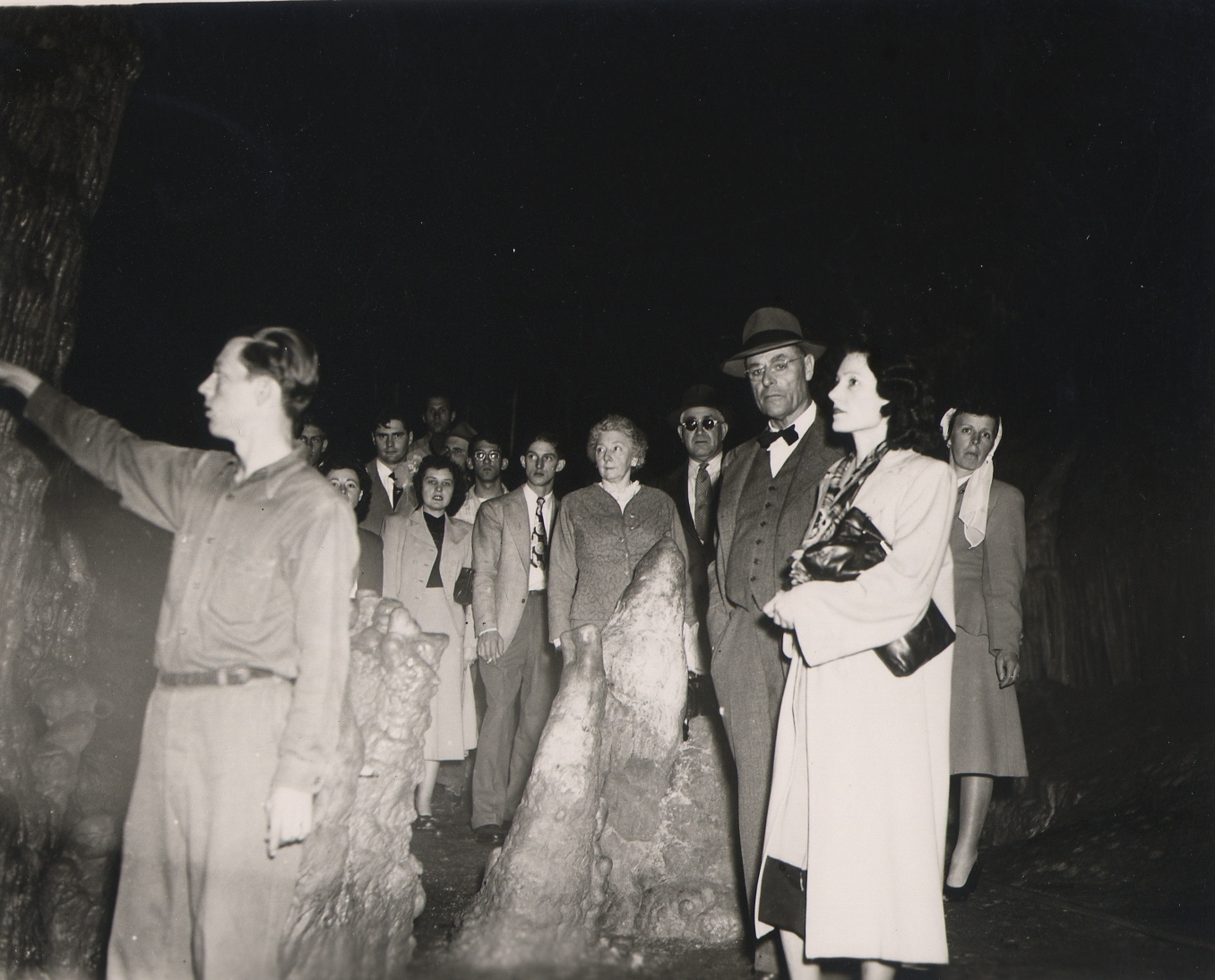 Black and white photo of people in a cave
