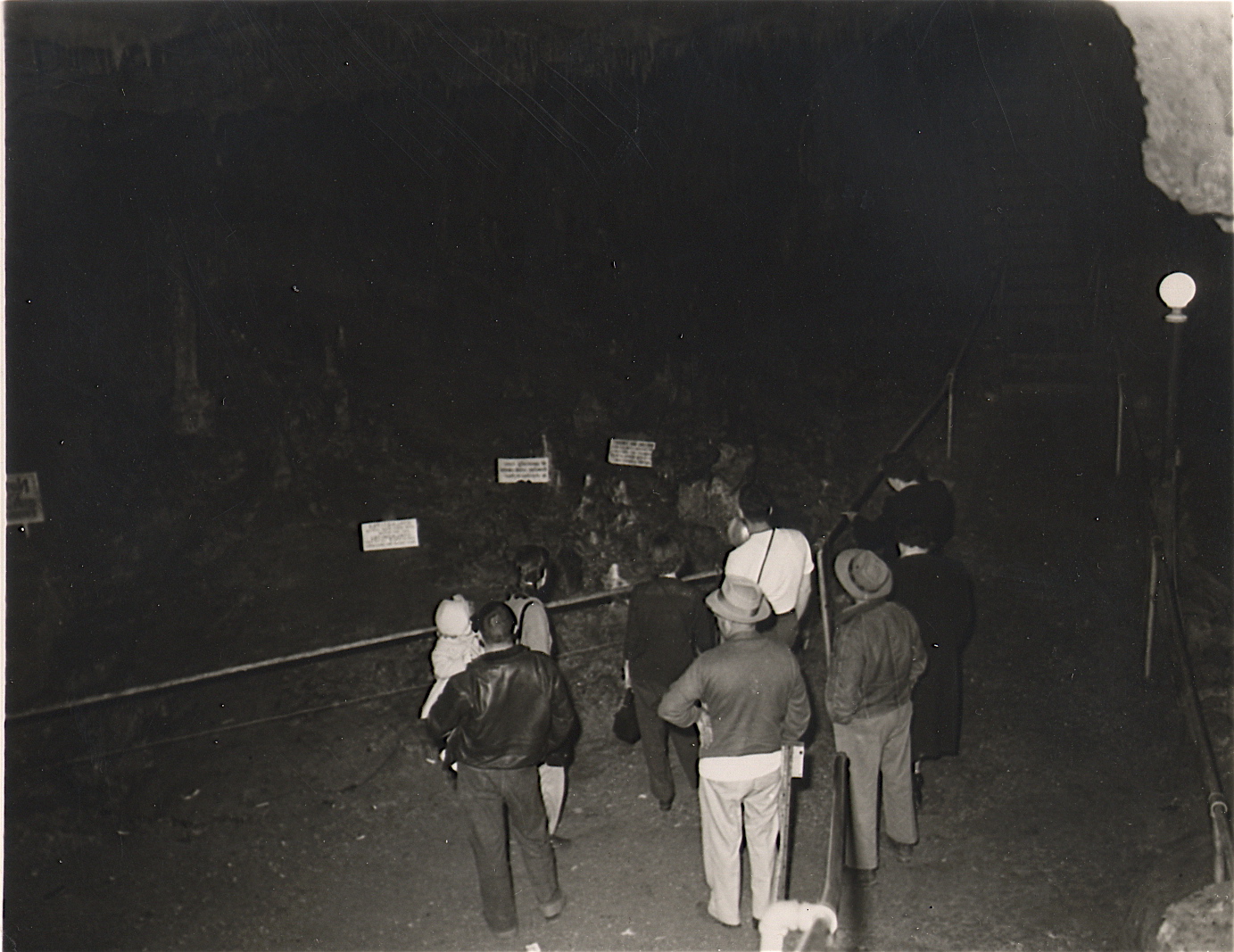 Black and white photo of people in a cave