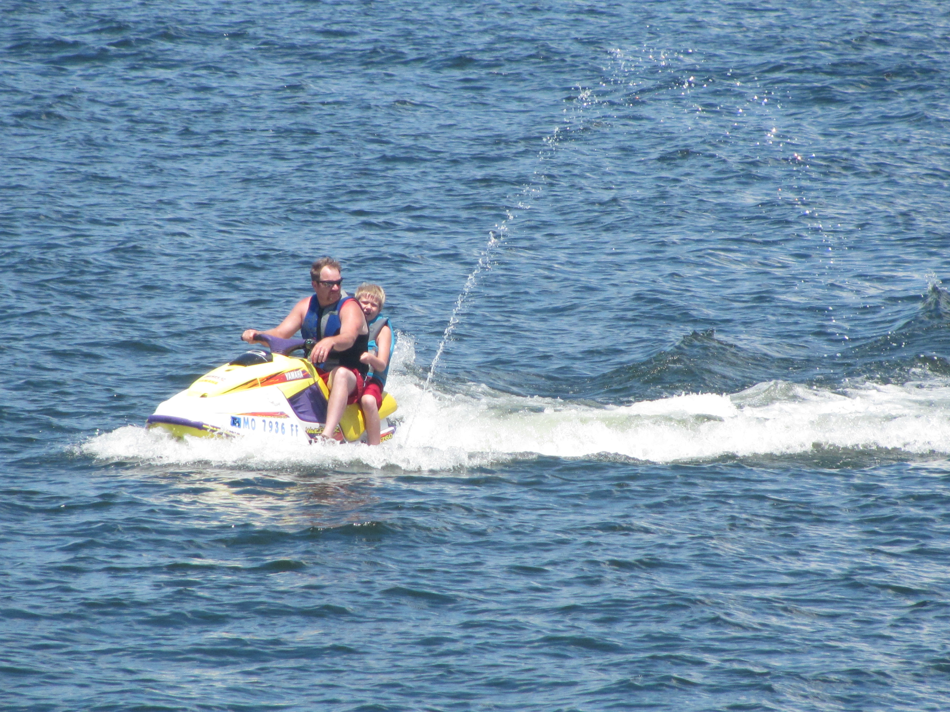 Two people on a jet-ski in a lake