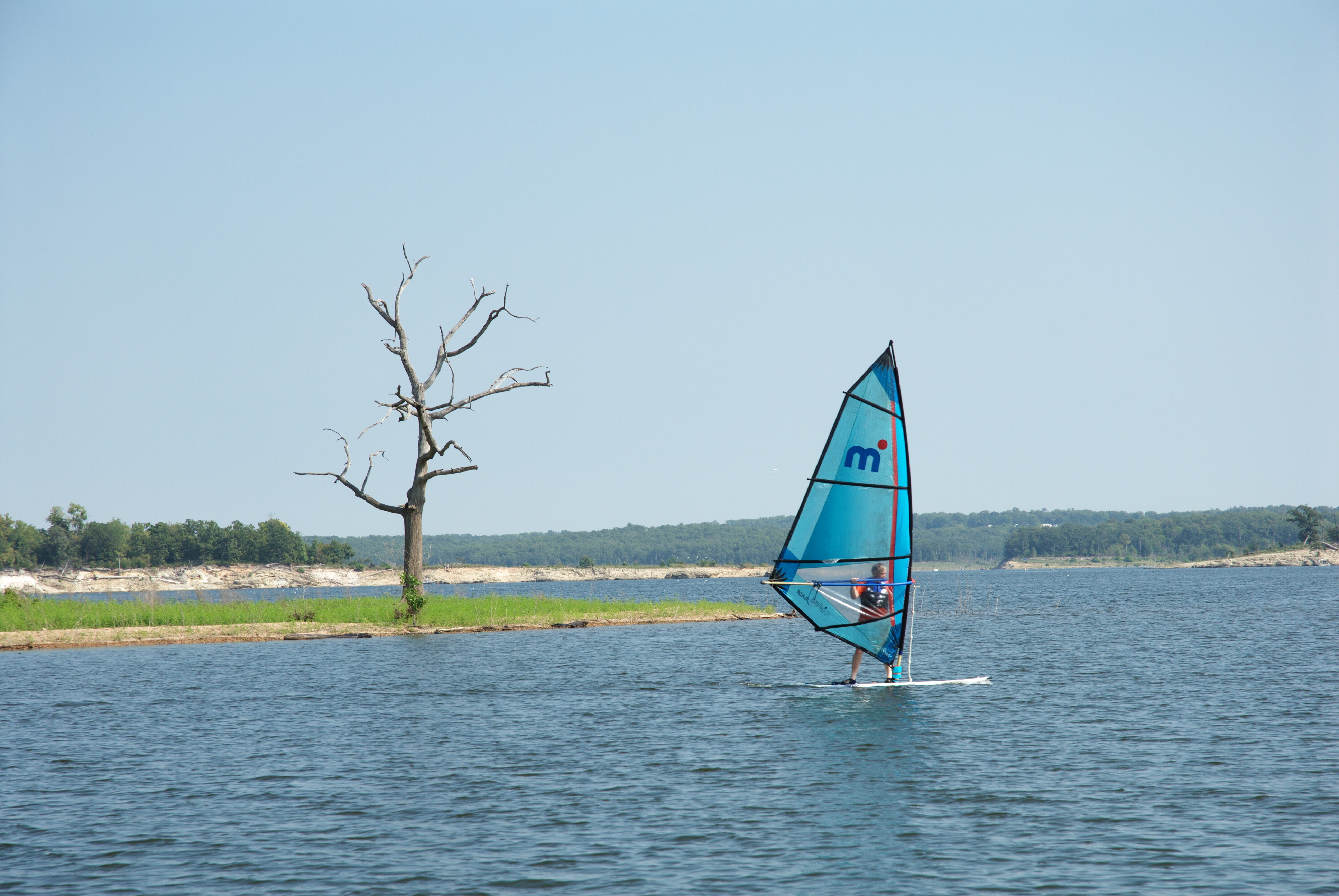 A person wind surfing on a lake