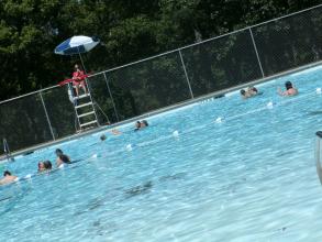 lifeguard watching people swim in the pool