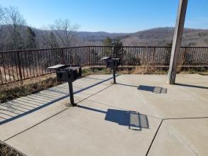 Two grills at a picnic shelter