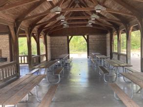 Picnic tables inside the open shelter