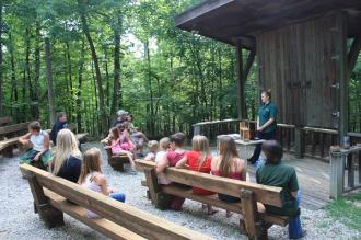 a group sits and listens to a program in the amphitheater