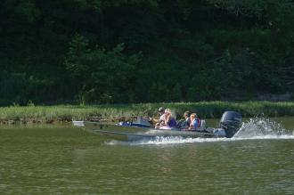 several people in a boat on the river