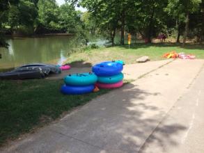 Floating tubes next to a concrete boat launch