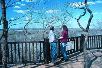 a couple looking at the view of the river from the overlook