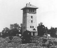 Black and white photo of tall brick building