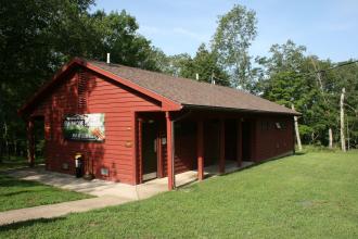 A red showerhouse with a path leading towards it