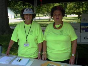 two volunteers working at a booth during the Katy Trail Ride