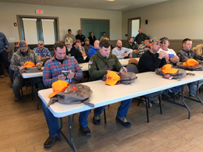 Hunters sitting in a conference room 