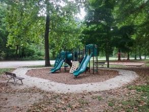 Playground structure with slides and a climbing wall