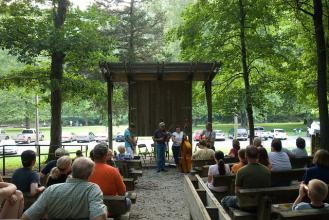 people sitting in the amphitheater watching a program
