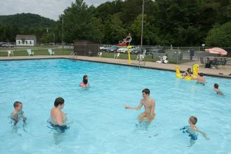 Kids playing in a swimming pool.