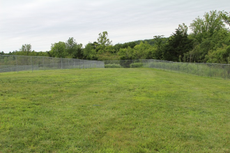 A large fenced-in grassy area