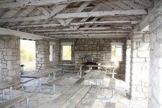 Interior of a stone shelter with wooden floors