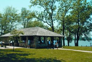 A stone picnic shelter at Lewis and Clark State Park next to the lake