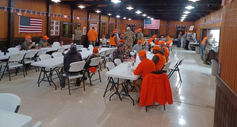 Men in eating inside a dining hall