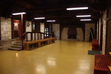 The main room of the enclosed shelter - an open area with a tile floor and benches along the walls