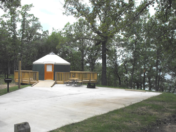 Yurt B in the distance with a concrete walkway in the foreground