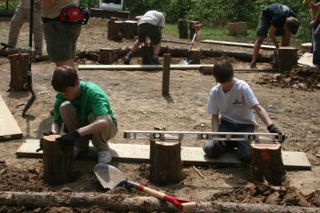 two Boy Scout working in a field