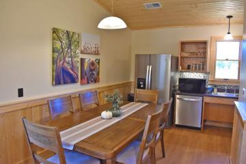 View of kitchen with table, chairs, and appliances