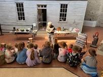 Students listen to a presentation inside the historic site museum
